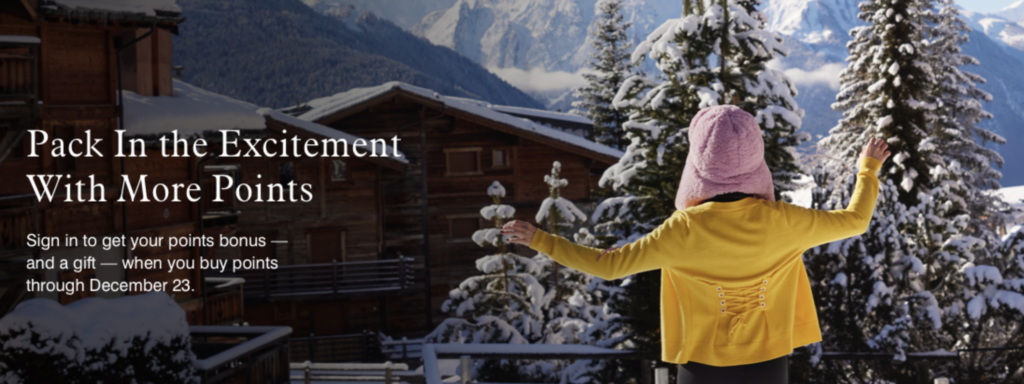 a woman standing in front of a snowy mountain